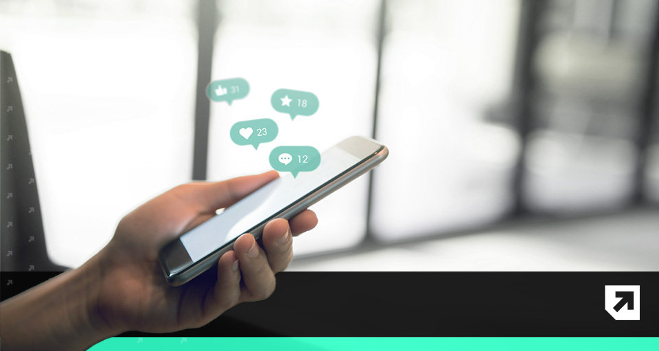 A person holding a phone with notifications popping up | How ABM aligns sales and marketing